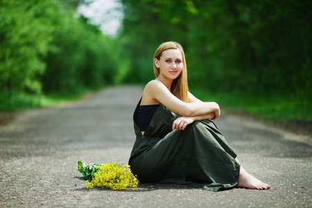 photo of beautiful blonde girl on the roadの写真素材