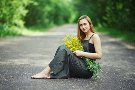 photo of beautiful blonde girl on the roadの写真素材
