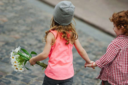 photo of two cute little hipsters running awayの写真素材