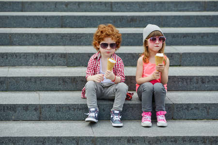photo of two cute hipsters eating icecreamの写真素材