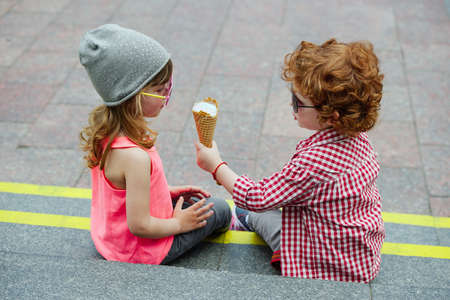 photo of two cute hipsters eating icecreamの写真素材