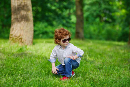 photo of little modern boy on the grassの写真素材