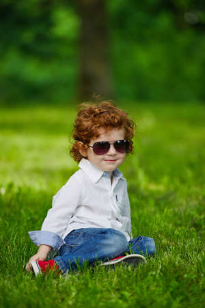 photo of little modern boy on the grassの写真素材