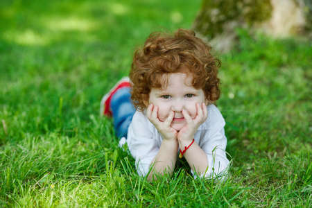 photo of little modern boy on the grassの写真素材