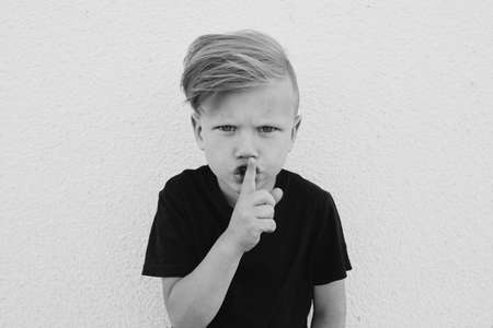 photo of young emotional boy on bright backgroundの写真素材