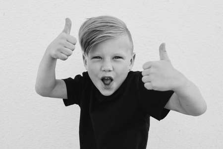 photo of young emotional boy on bright backgroundの写真素材