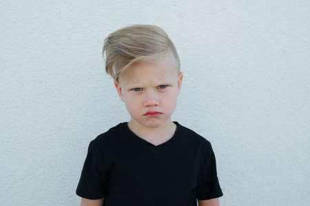 photo of young emotional boy on bright backgroundの写真素材