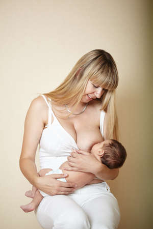 photo of young mother feeding her little babyの写真素材
