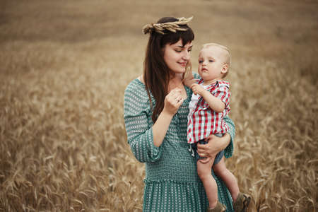 photo of happy mother with son in the fieldの写真素材