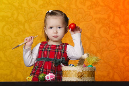 photo of little girl painting easter eggs