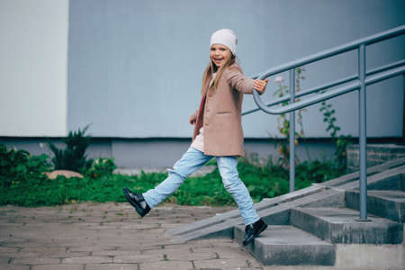 photo of beautiful young girl posing on the streetの写真素材