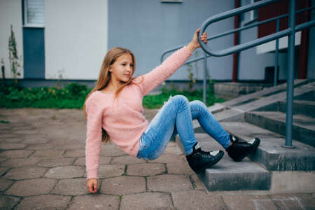 photo of beautiful young girl posing on the streetの写真素材