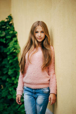 photo of beautiful young girl posing on the streetの写真素材