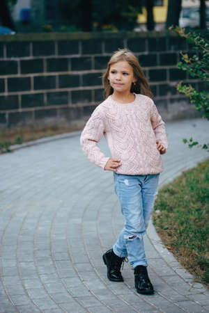 photo of beautiful young girl posing on the streetの写真素材