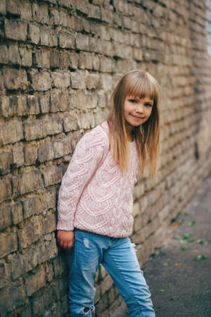 photo of beautiful young girl posing on the streetの写真素材