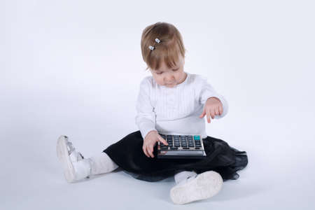 photo of cute little girl with calculatorの写真素材