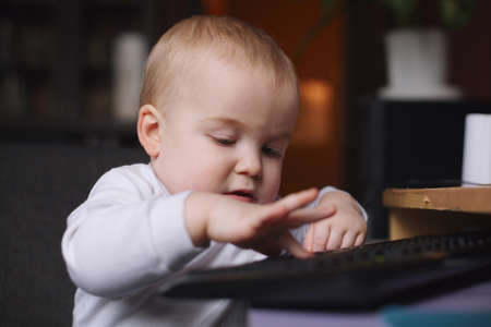 photo of little funny boy using computerの写真素材