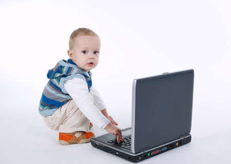 photo of cute boy with laptop on white