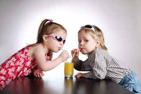 boy and girl drinking juiceの写真素材