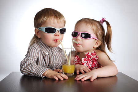 boy and girl drinking juiceの写真素材