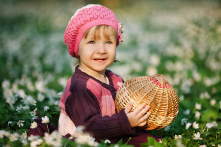 beautiful little girl in forest on flowers fieldの写真素材