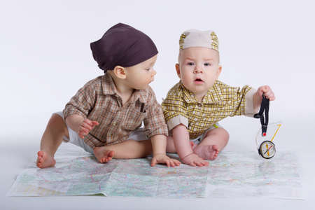 cute babies planning travel with mapの写真素材