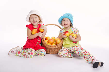 two funny girls with apple harvestの写真素材