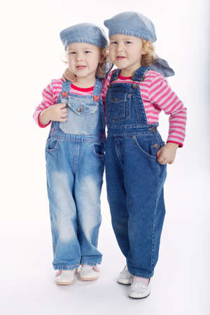 little twin girls isolated on white backgroundの写真素材