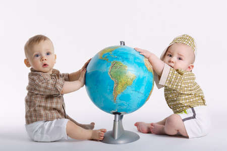 little funny boy with globe on whiteの写真素材