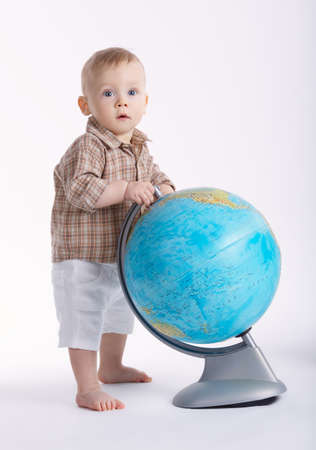 little funny boy with globe on whiteの写真素材