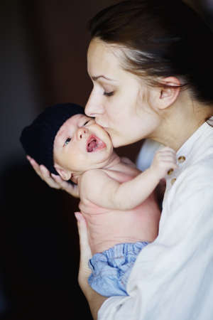young mother with baby at homeの写真素材
