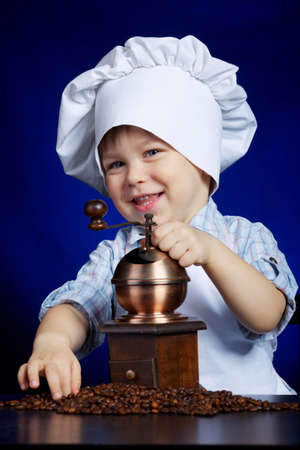 little boy plays with coffee millの写真素材