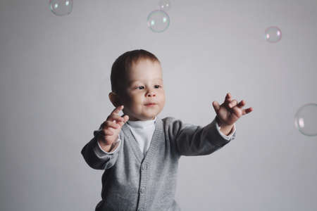 little funny boy plays with bubblesの写真素材