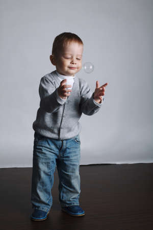 little funny boy plays with bubblesの写真素材
