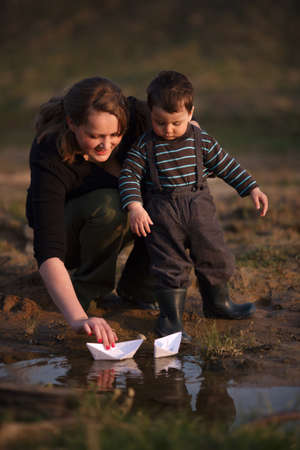 mother and son play paper boatsの写真素材