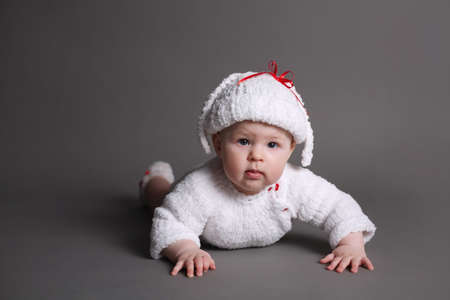 beautiful baby in a knit dress and capの写真素材