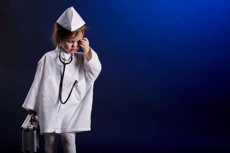 little girl with doctors uniformの写真素材