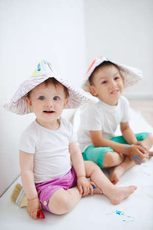 Happy children painting wall at homeの写真素材