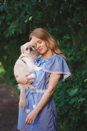 young beautiful girl with pekingeseの写真素材