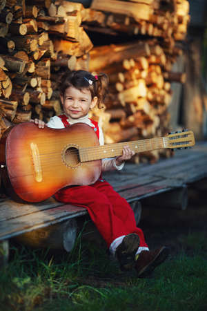 cute little girl with guitarの写真素材