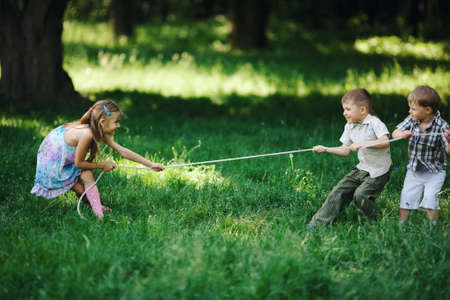 children pulling the rope outdoorsの写真素材