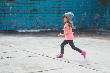cute little hipster girl running awayの写真素材