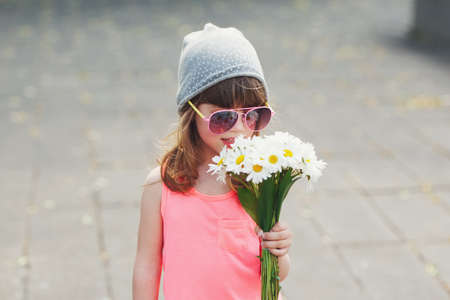 beautiful little hipster girl with flowersの写真素材