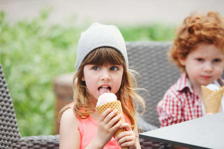 two cute hipsters eating icecreamの写真素材