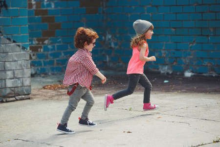 two cute little running hipstersの写真素材