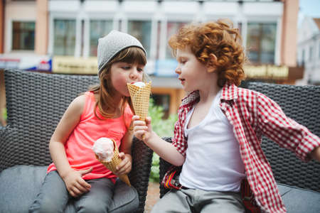 two cute hipsters eating icecreamの写真素材