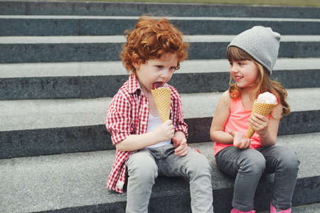 two cute hipsters eating icecreamの写真素材