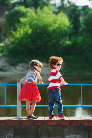 cute little hugging children on the promenadeの写真素材