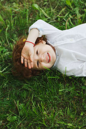 little modern boy on the grassの写真素材