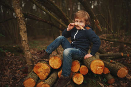little sweet lumberjack in autumn forest